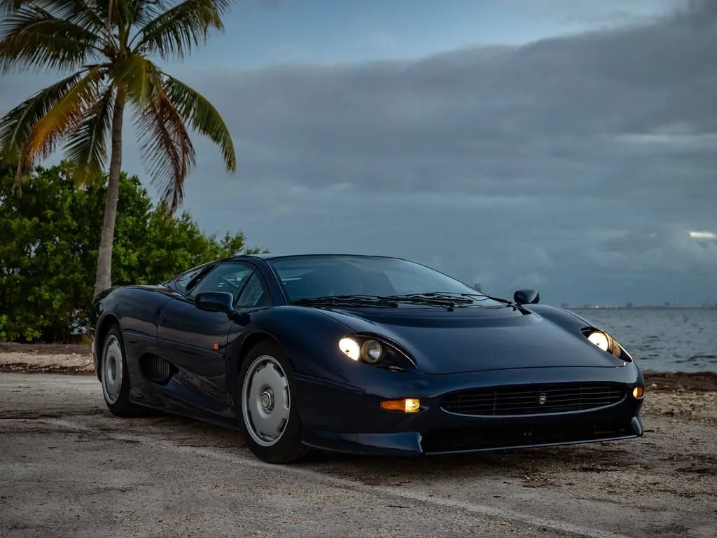 Jaguar XJ220 1994 model displayed in showroom lighting highlighting updated production details