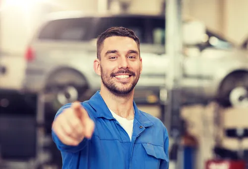 automotive service professional working on modern vehicle engine components