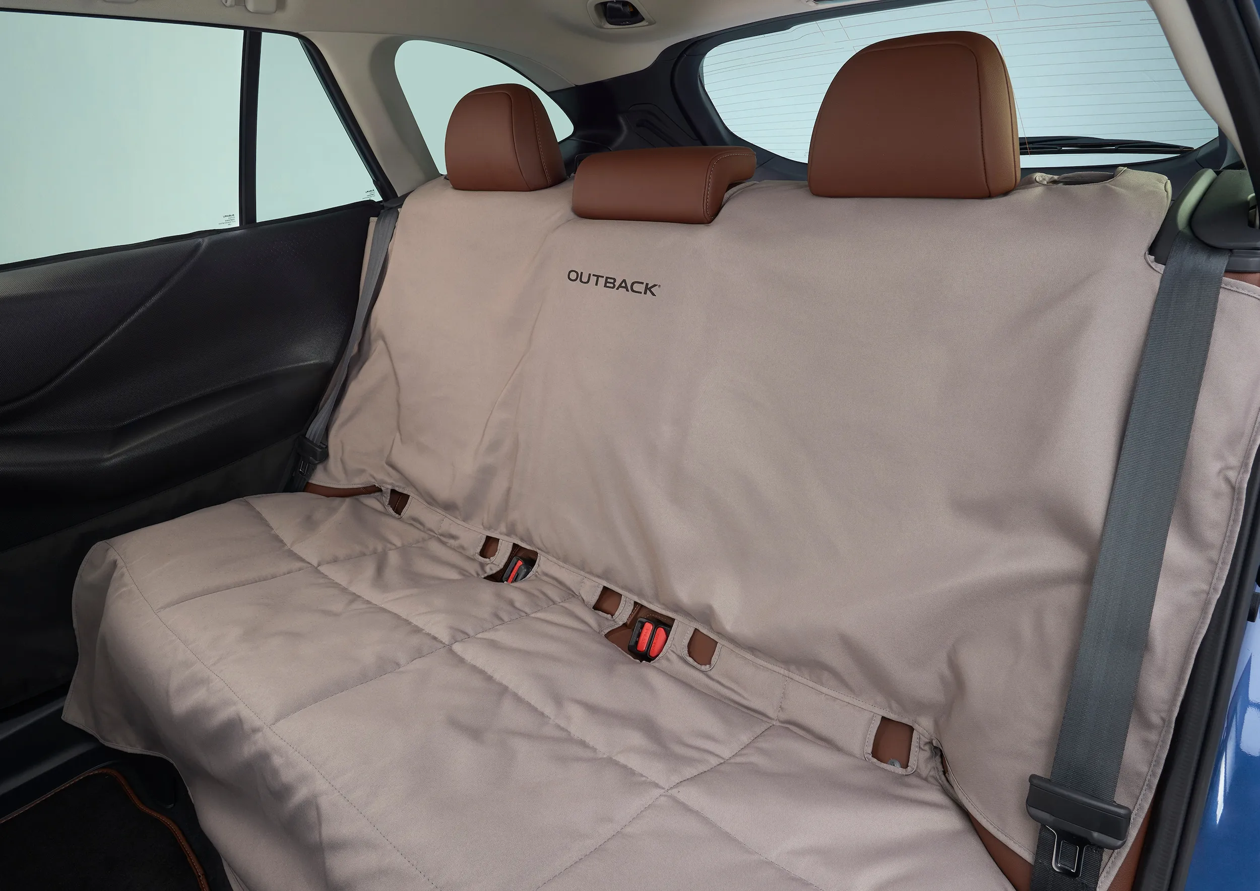 Padded rear seat cover installed in a Subaru back seat for pet and passenger protection