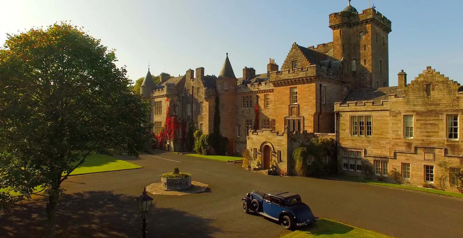 Historic castle estate overlooking a lake in Scotland