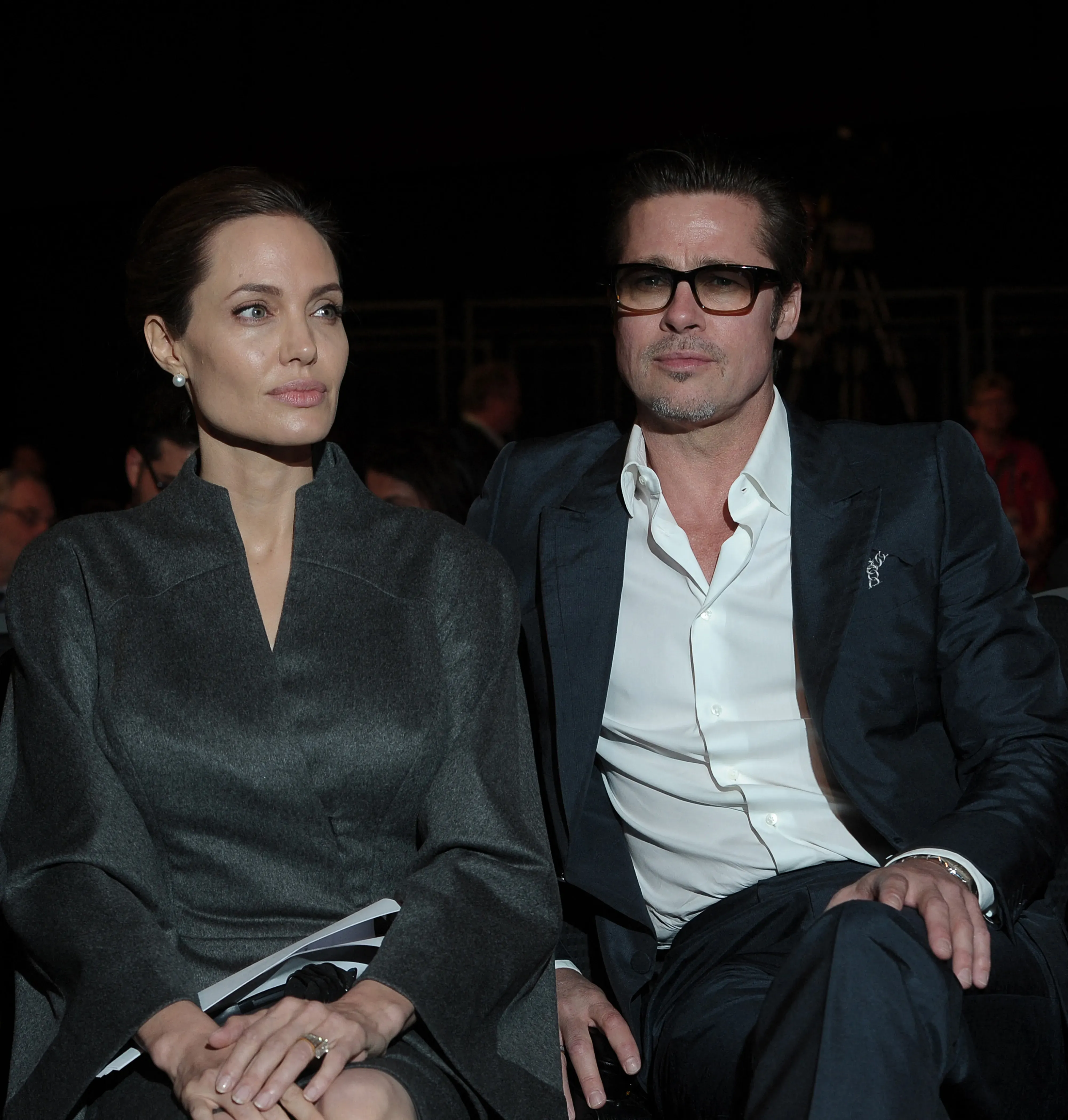 Angelina Jolie and Brad Pitt sit side-by-side at the Global Summit to End Sexual Violence in Conflict.