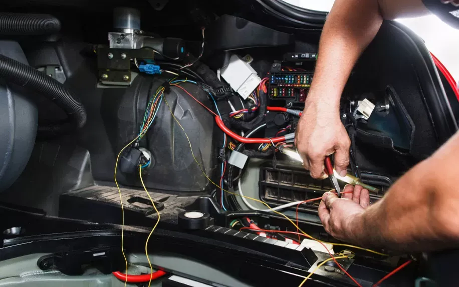 Close-up of automotive electrical wiring and component testing