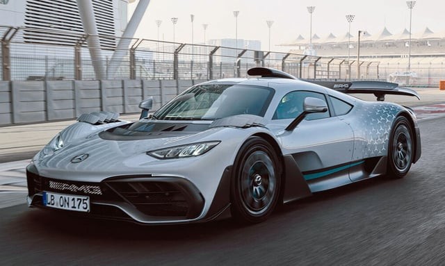 Modern luxury supercars parked on a scenic coastal highway under golden hour sunlight, representing the best super cars of 2022