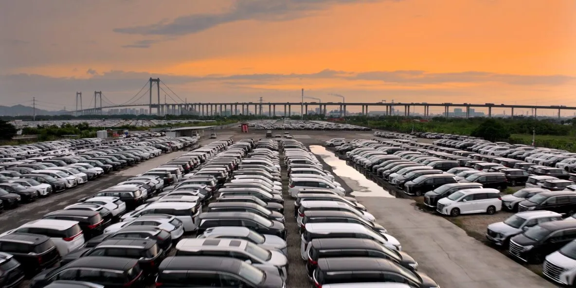 Generic car dealership lot with vehicles parked in rows
