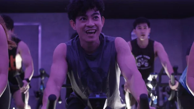 Indoor cycling studio with rows of stationary bikes
