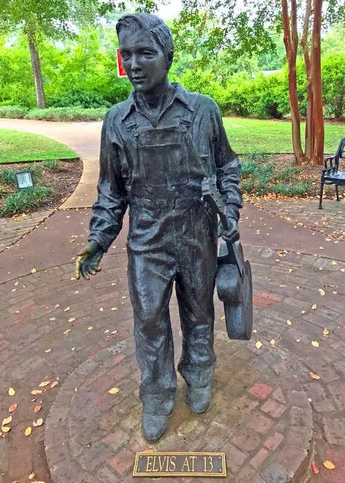 Life-sized bronze statue of thirteen-year-old Elvis Presley wearing oversized overalls