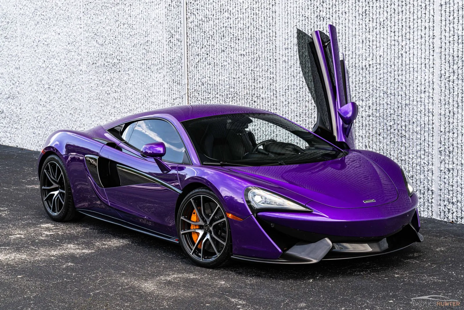 McLaren 570S parked showcasing its signature dihedral doors