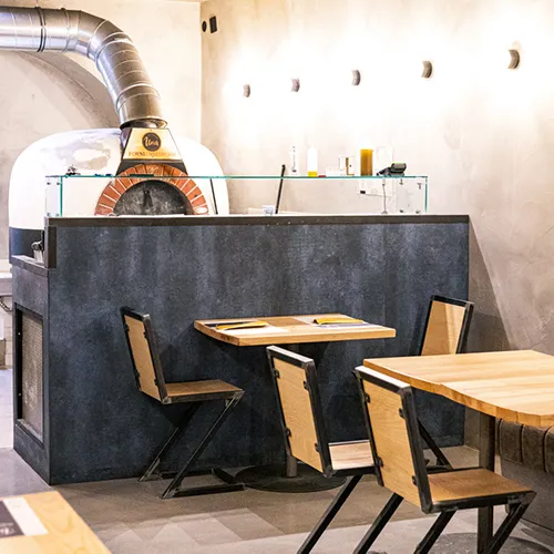 Interior view of UNA Pizza showing cozy dining space