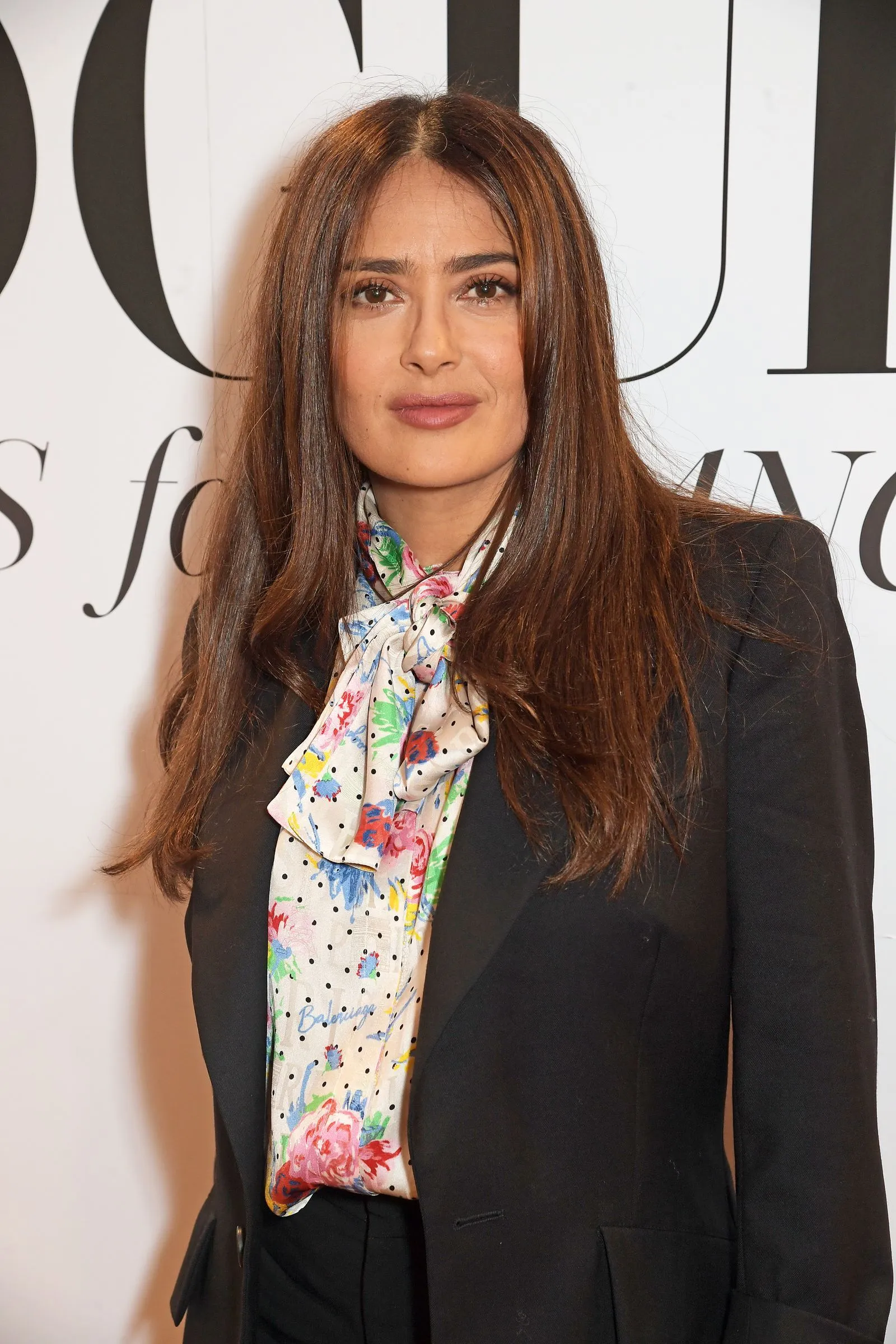 Salma Hayek with long layered hair featuring soft bends at the ends