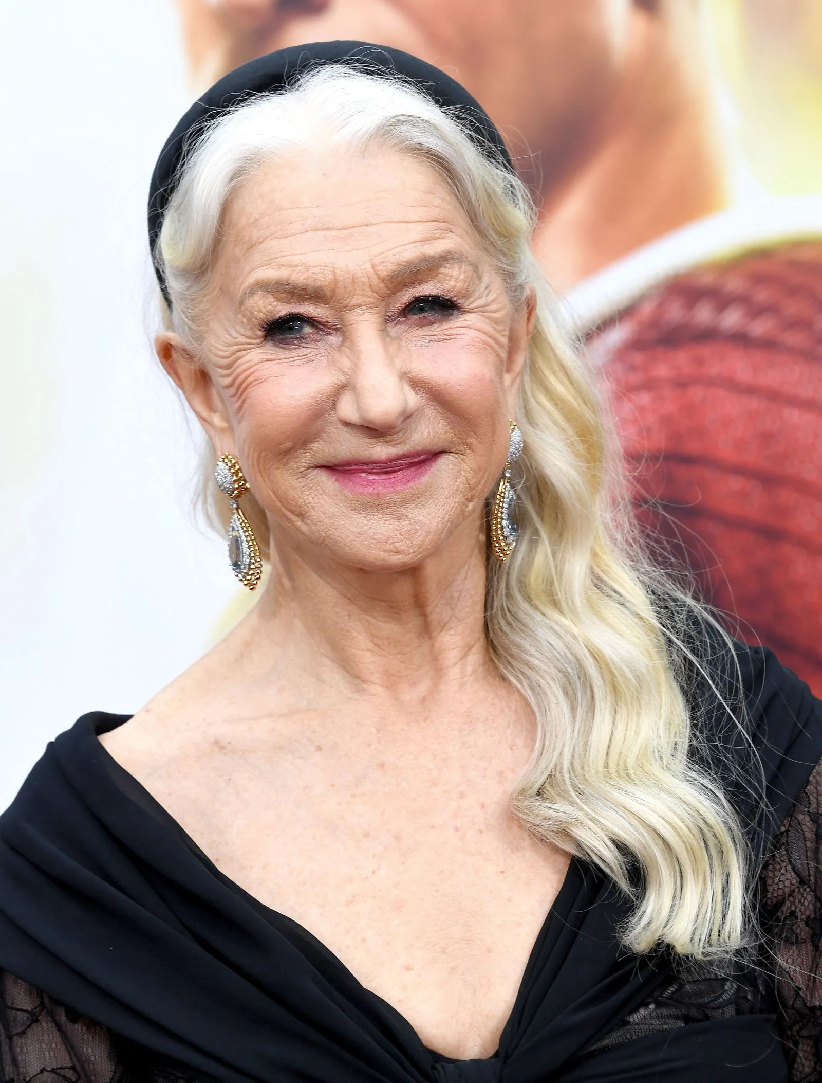 Helen Mirren wearing a black satin headband with silver hair