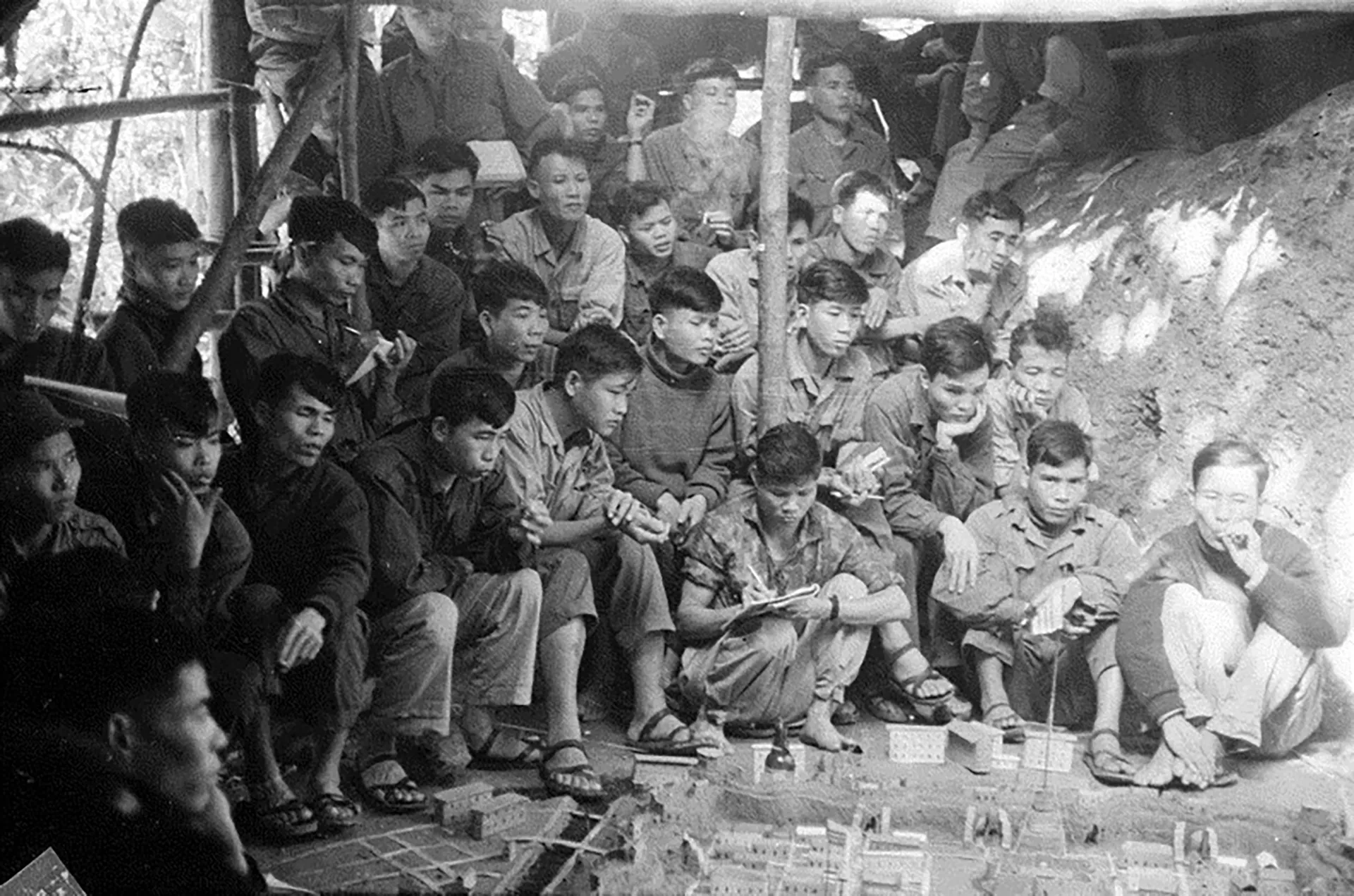 Soldiers studying a sand-table model ahead of an assault near Hue