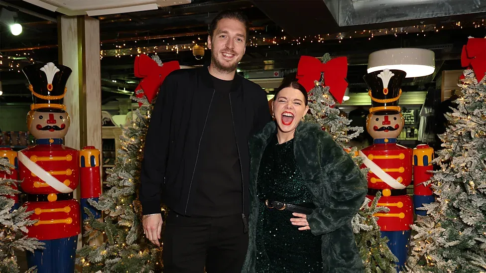 LadBaby, made up of Mark and Roxanne Hoyle, posing together at a festive launch event