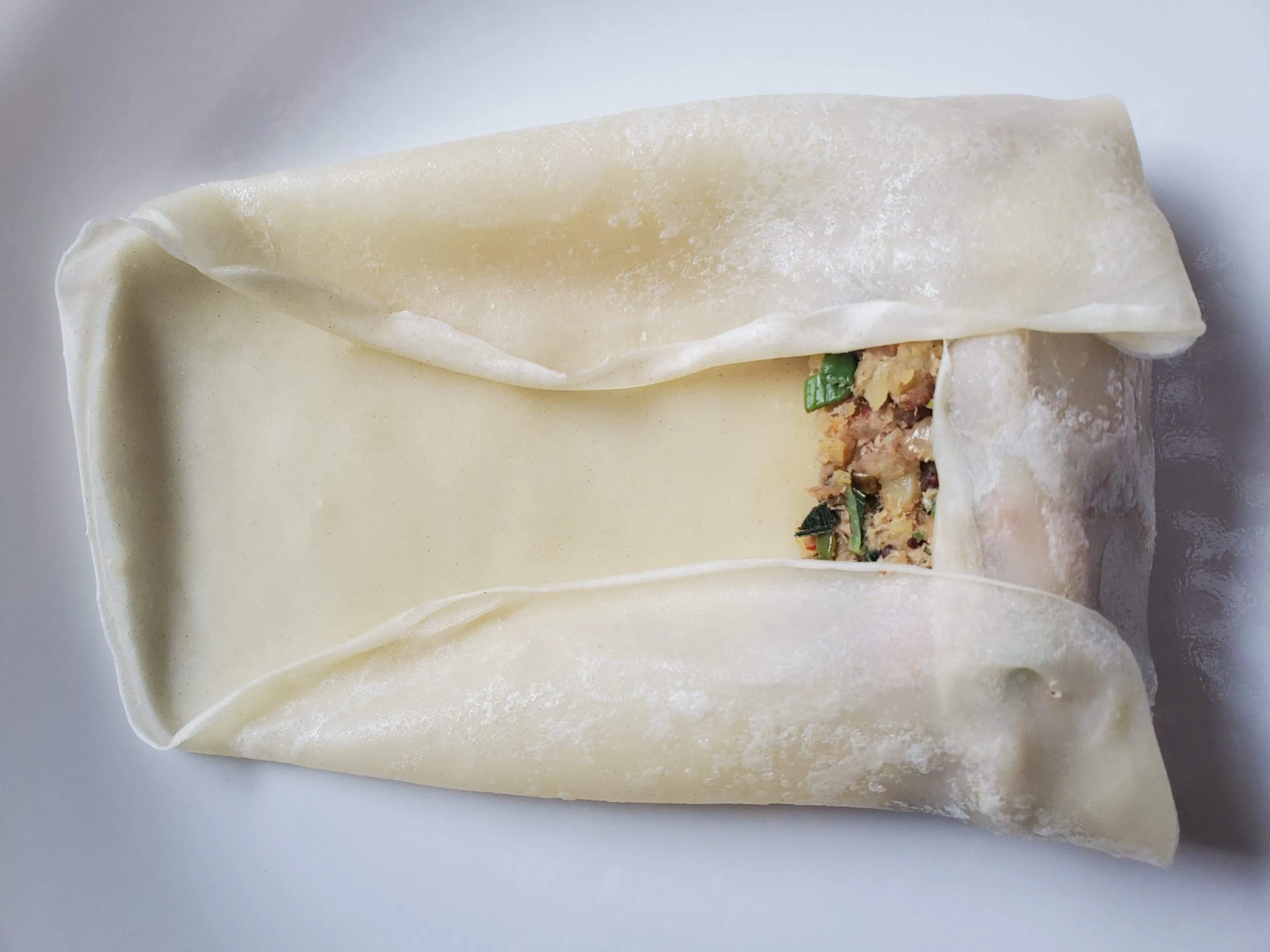 Filling wrapped inside a thin pancake before rolling
