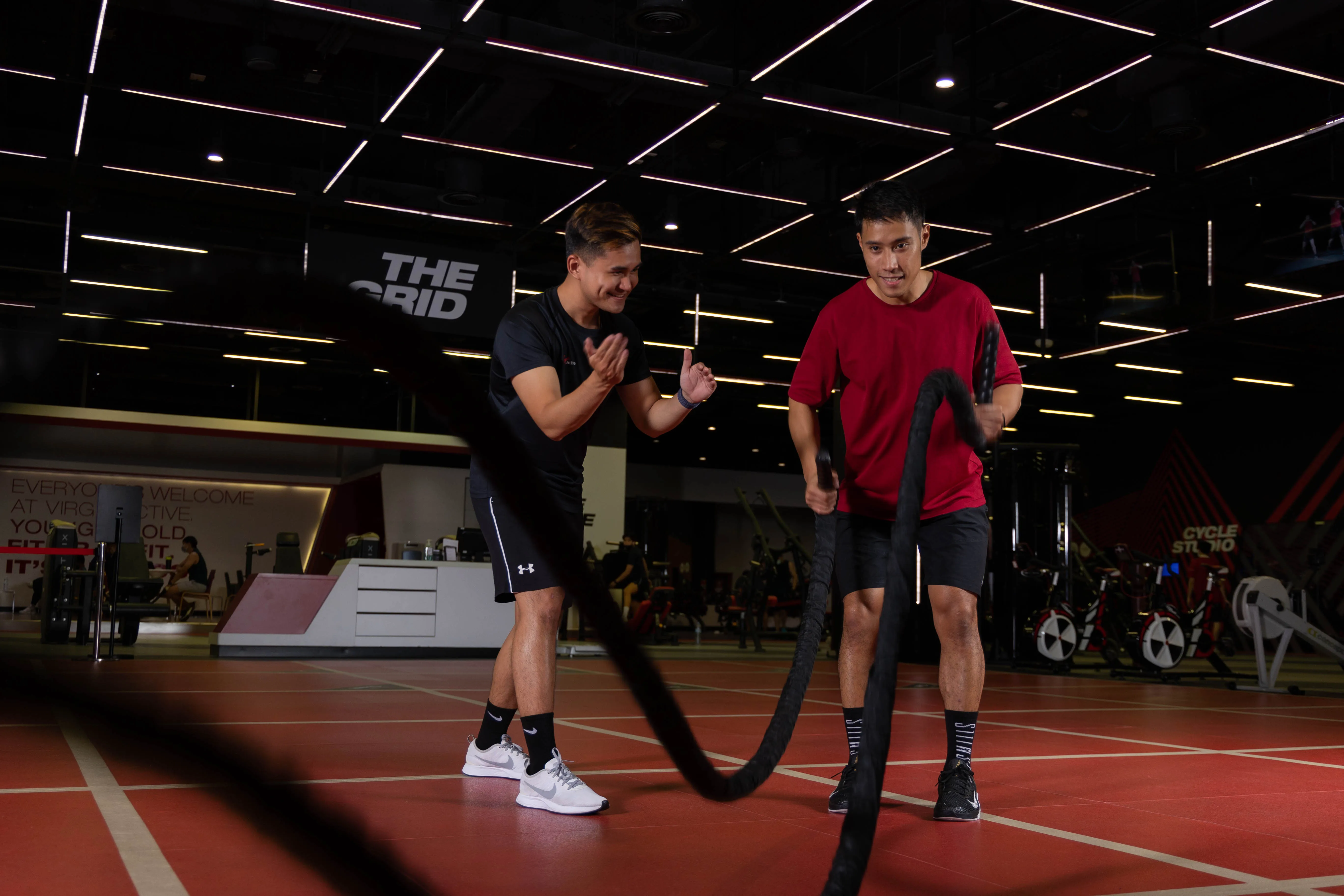 Personal trainer working one-on-one with a client in a gym setting