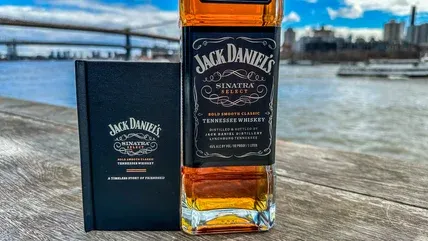 Bottle of Jack Daniel's Sinatra Select displayed alongside its accompanying fact book