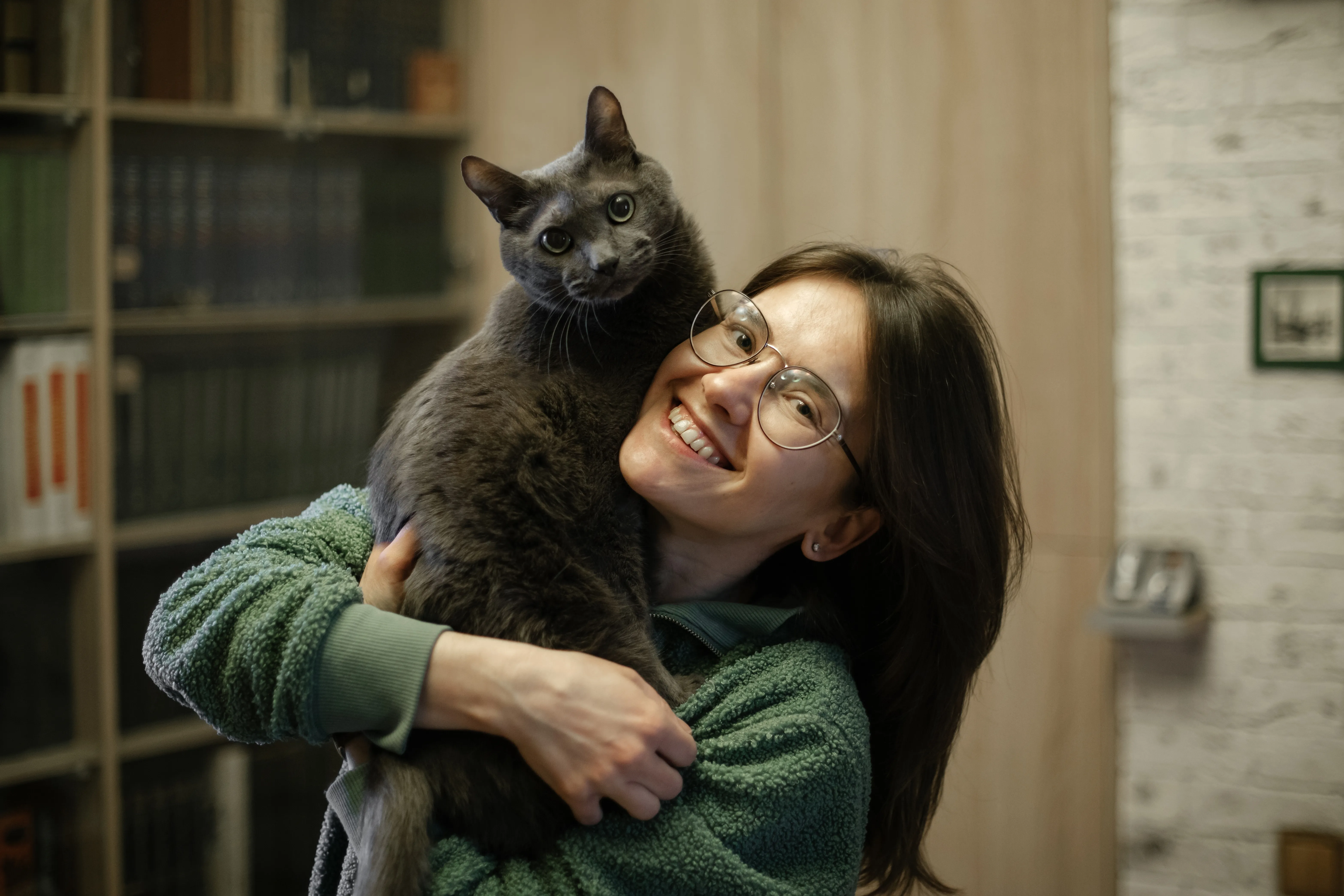 Woman relaxing with a cat curled up nearby