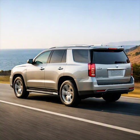 A silver 2015 Cadillac Escalade Luxury showing its iconic tall grille and LED lighting on an open road