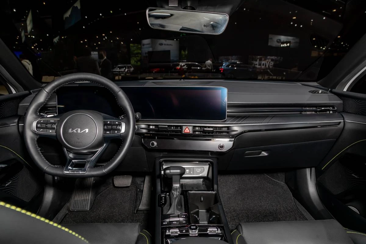 2022 Kia K5 GT-Line sedan in sleek black finish, parked in a modern urban setting