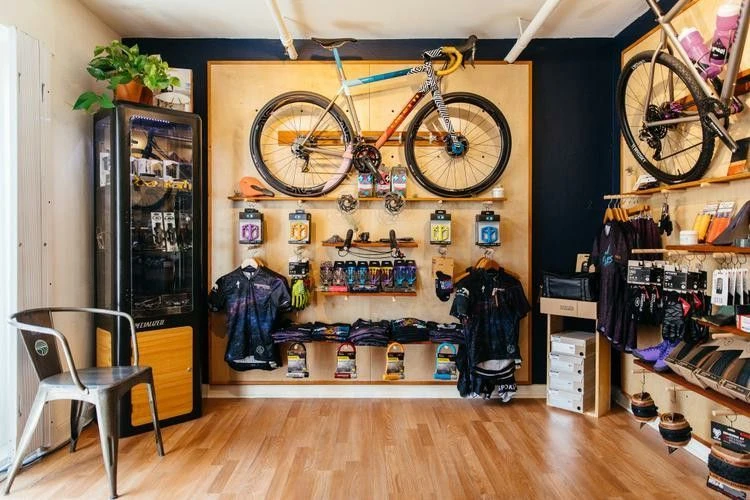 Display of high performance road bikes and professional cycling accessories inside a specialty bicycle shop showroom