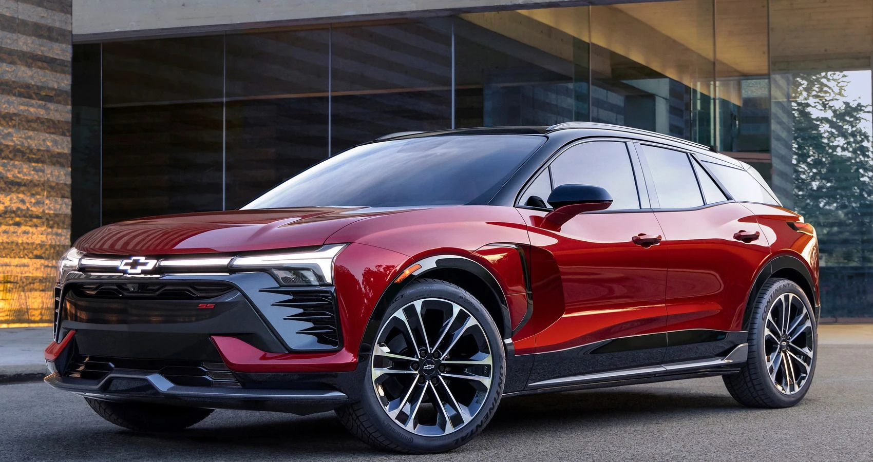 Sporty electric crossover SUV featuring sharp exterior design lines and modern LED headlights in a bright studio setting