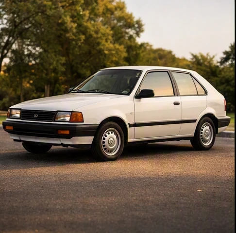 Well-preserved vintage compact car parked in a driveway, showing clean body panels and maintained exterior trim details