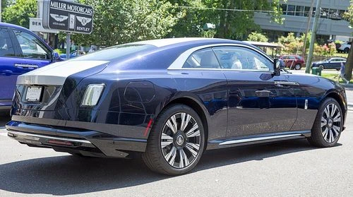 Side-by-side visual comparison of EPA and WLTP testing certification labels on luxury electric vehicle