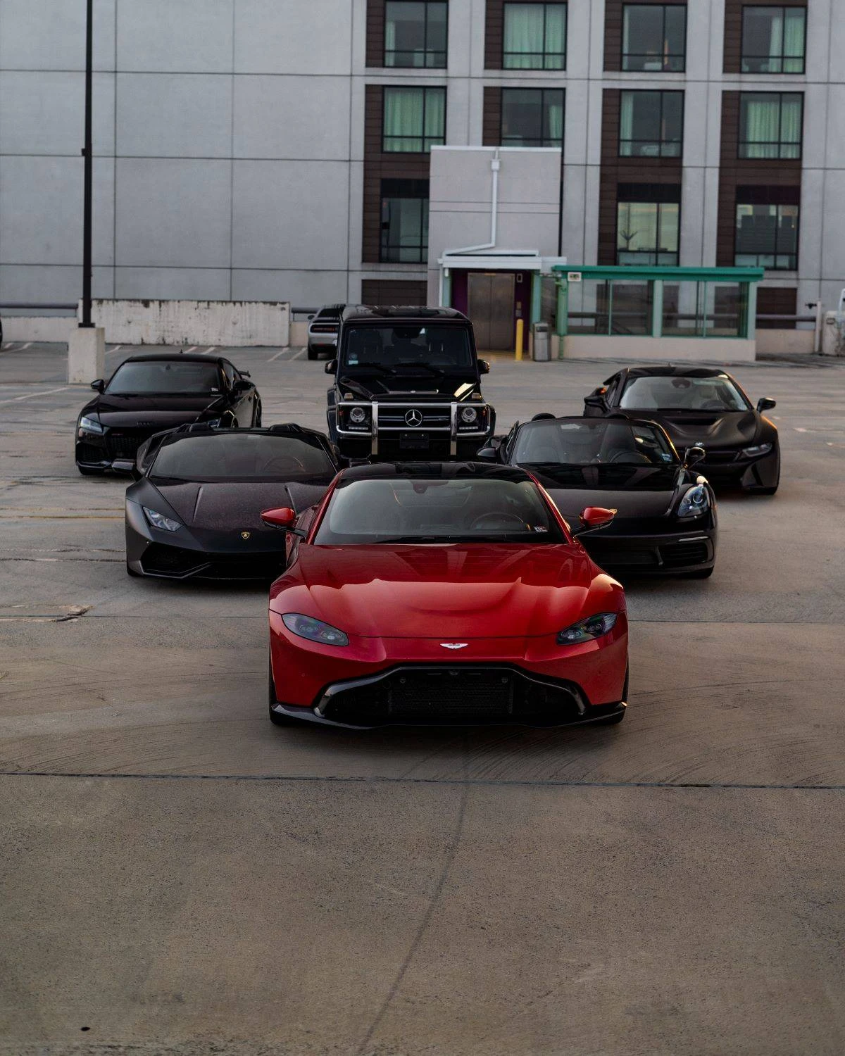 Exotic car dealership service desk with staff reviewing vehicle documentation and financing paperwork with a customer
