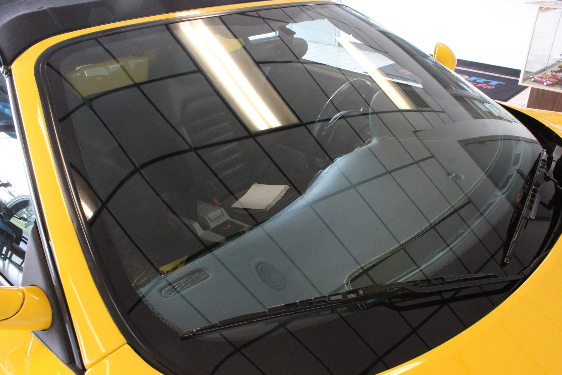 Buyer performing test drive of exotic sports car while checking dashboard indicators and vehicle operation during dealership verification process