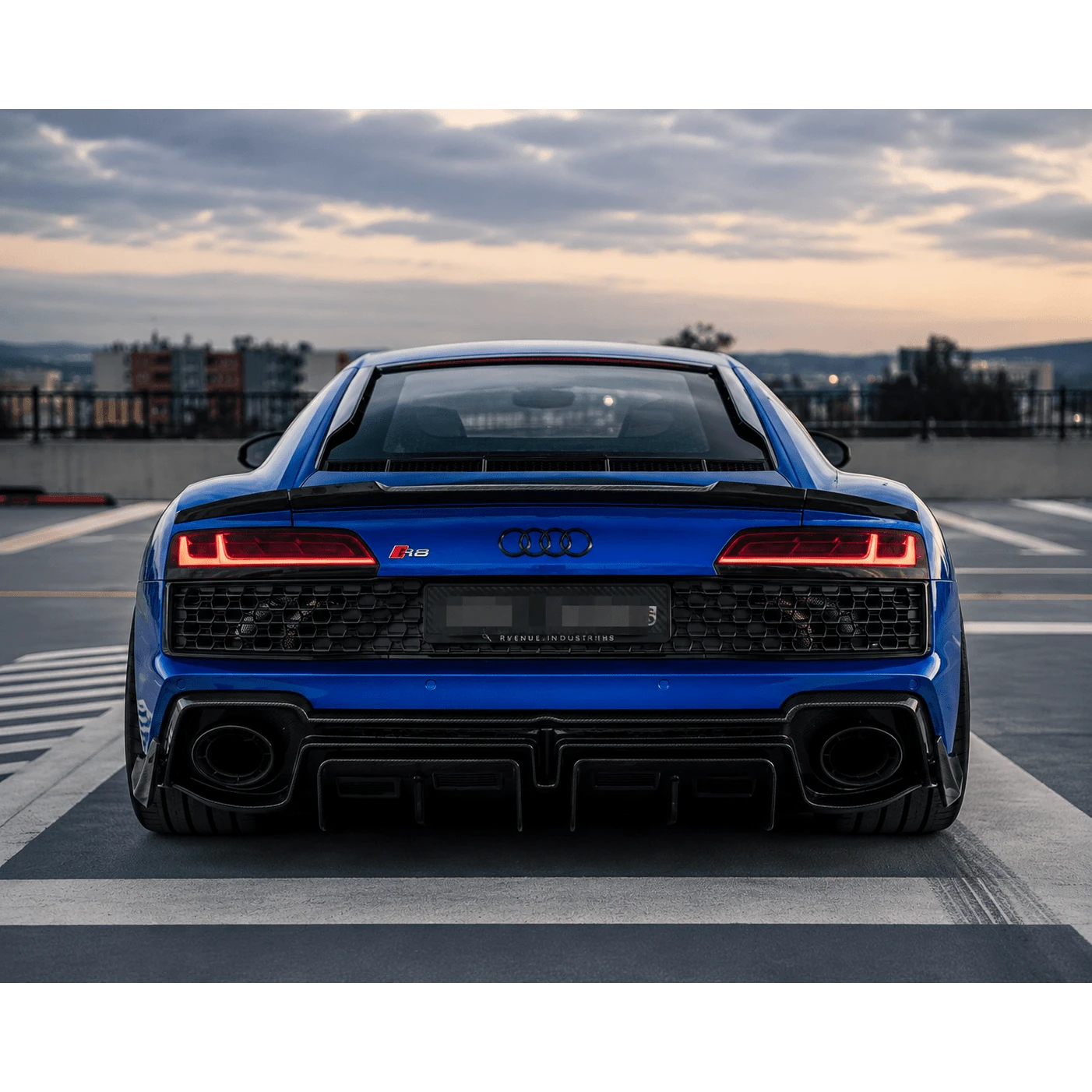 Aerodynamic exotic supercar parked on a scenic coastal road at twilight