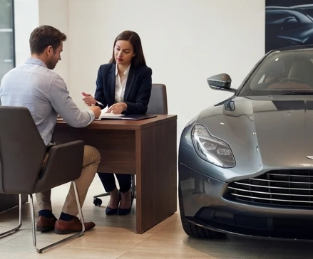 Buyer reviewing luxury car purchase agreement details before final vehicle transaction