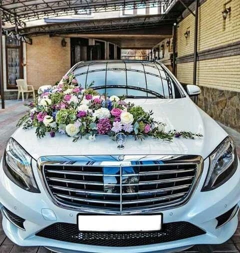 A sleek black luxury sedan parked on a clean, modern street in Bangalore during golden hour, representing a premier self-drive rental experience