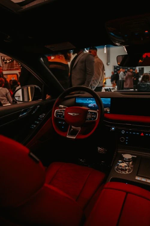 An elegant luxury sedan cabin showcasing premium leather seats, advanced infotainment display, and fine wood trim details