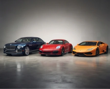 Three luxury vehicles side by side showing sedan, sports car, and exotic car tiers