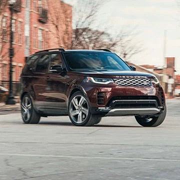 Electric SUV maintenance items including tires cabin filters and service equipment arranged in a garage setting