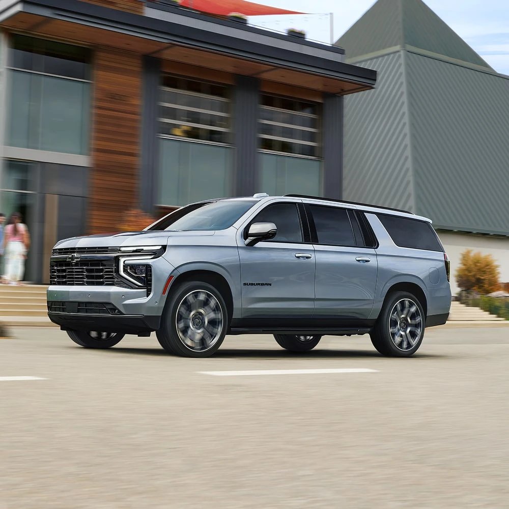 Electric SUV traveling on an open highway during realistic road conditions and changing weather