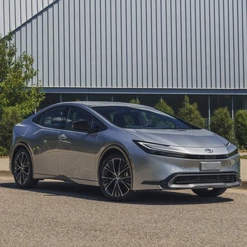 Electric SUV with different configuration considerations including wheels and exterior options in a showroom setting