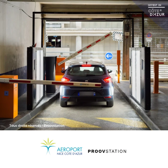 Modern compact car parked at Nice Côte d'Azur Airport terminal, ready for rental pickup with scenic Mediterranean backdrop